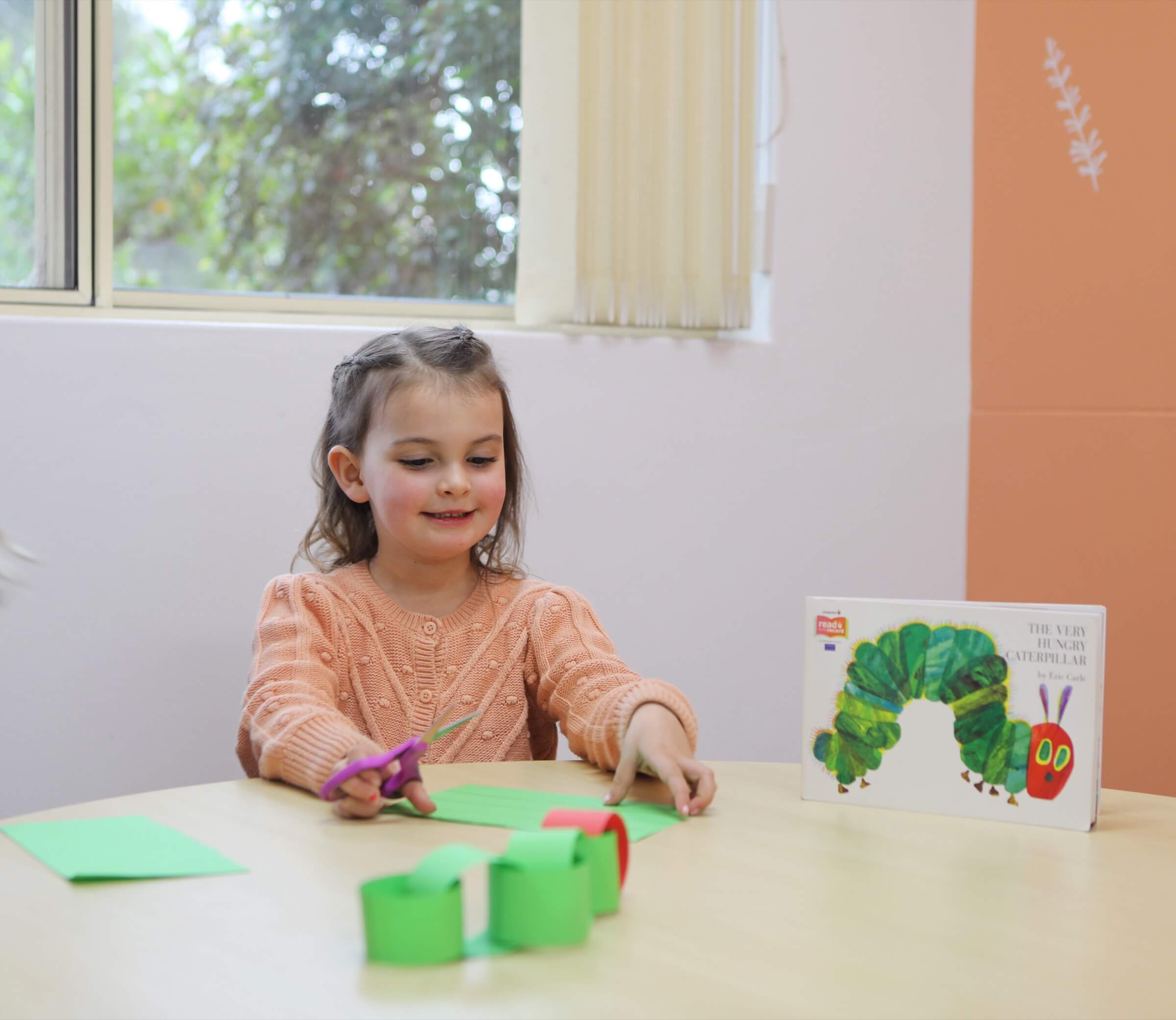 A cute girl playing with colorful papers