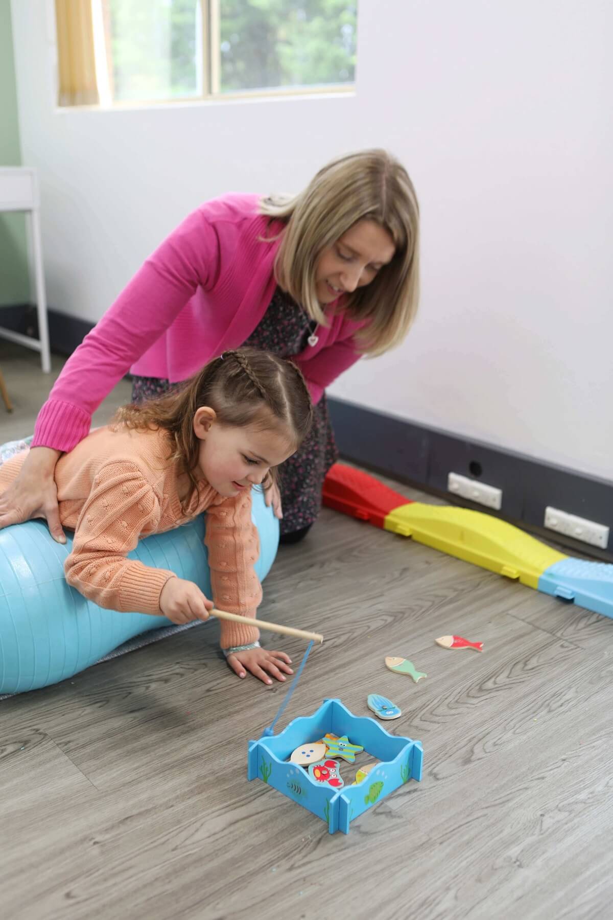 Occupational therapist is playing with a kid